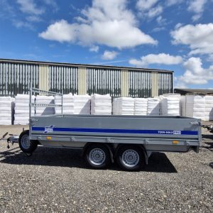 Ifor Williams TM272-3617 Tow-Max Pro Flatbed Trailer side view under sky