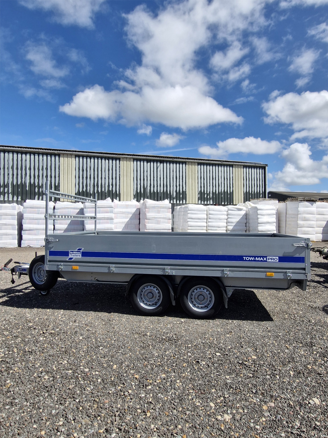 Ifor Williams TM272-3617 Tow-Max Pro Flatbed Trailer side view under sky