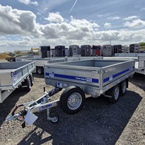 Ifor Williams Tow-Max Pro flatbed trailer with blue striped side in yard